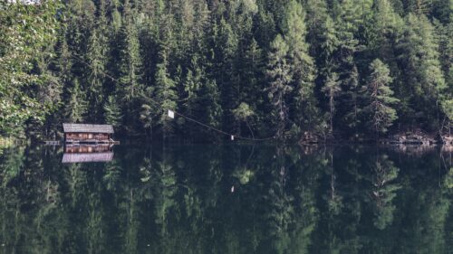 Rustic Wooden Cabin by a Serene Forest Lake Desktop Wallpaper