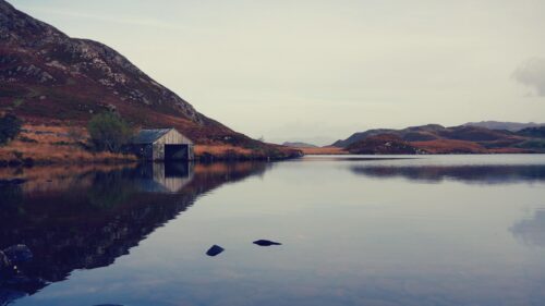 Serene Scottish Highlands Landscape with Old Boathouse Desktop Wallpaper