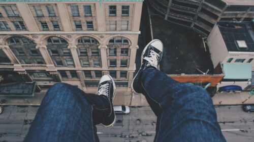 Dangling Feet Over City Street Perspective Desktop Wallpaper