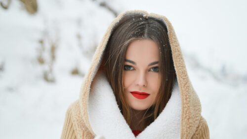 Beautiful Woman in Winter Landscape with Beige Hooded Coat 4K Wallpaper