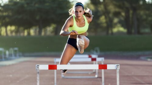 Athletic Female Hurdle Runner Focused Performance 4K Wallpaper
