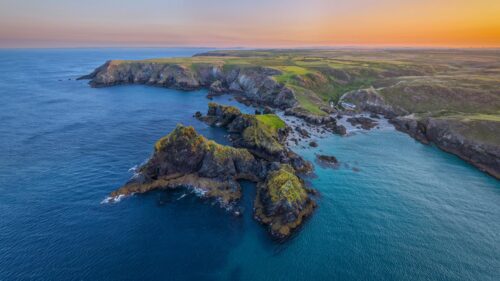 Breathtaking Sunset Over Rugged Coastal Cliffs and Turquoise Ocean Desktop Wallpaper