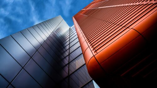 Modern Architectural Abstract Skyscraper with Copper and Silver Facade 4K Wallpaper