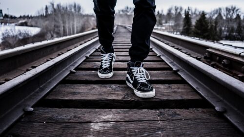 Person Walking on Old Train Tracks Aesthetic PC Wallpaper