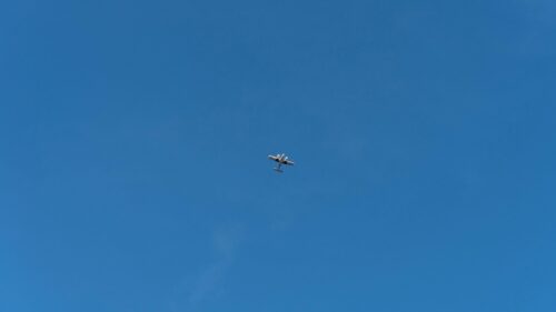 Minimalist Small Airplane Flying in Clear Blue Sky PC Wallpaper