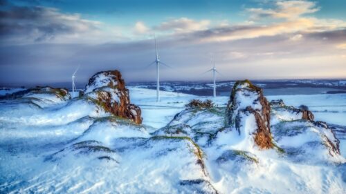 Snowy Mountain Landscape with Wind Turbines at Sunset PC Wallpaper