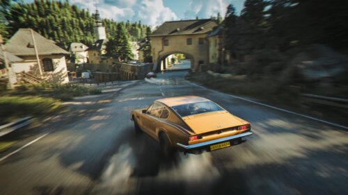 Golden Aston Martin Classic Car Speeding Through European Village PC Wallpaper