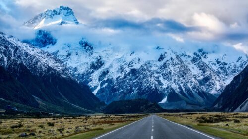 Scenic Road Leading to Snowy Mount Cook Peaks Desktop Wallpaper