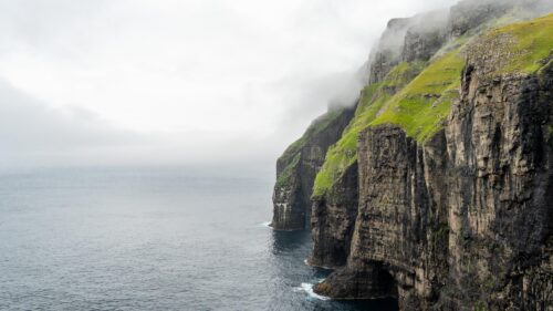 Misty Faroe Islands Cliffside Ocean View 4K Wallpaper
