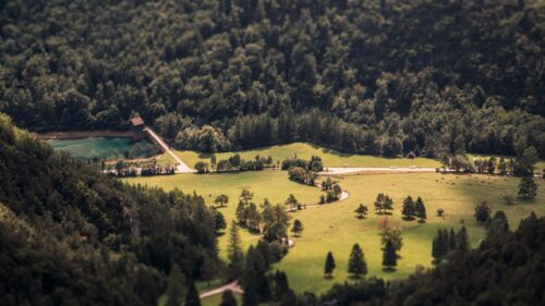 Tilt-Shift Aerial View of Scenic Alpine Valley and Lake Desktop Wallpaper