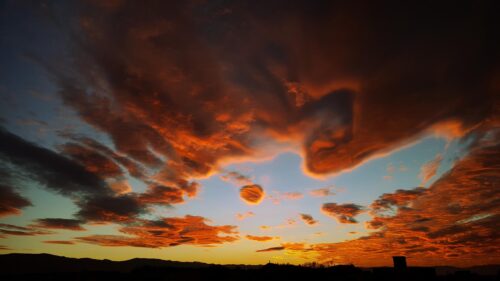Dramatic Fiery Sunset Clouds Over Mountain Horizon 4K Wallpaper