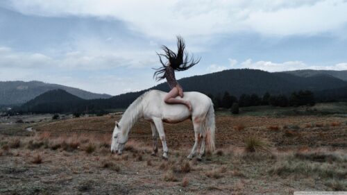 Woman Riding White Horse in Moody Mountain Landscape PC Wallpaper