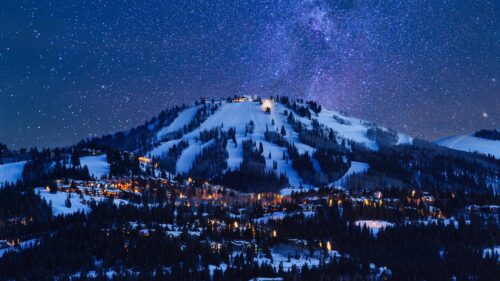 Breathtaking Snowy Mountain Ski Resort Under a Starry Milky Way Night Sky 4K Wallpaper
