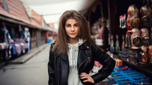 Beautiful Young Woman in Leather Jacket at a Street Market Desktop Wallpaper