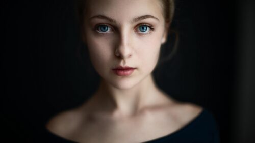 Stunning Portrait of a Young Woman with Piercing Blue Eyes PC Wallpaper
