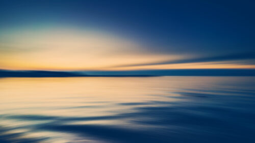 Abstract Motion Blur Sunset Over Calm Ocean Desktop Wallpaper