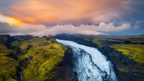 Breathtaking Aerial View of Icelandic Glacier and Green Mossy Mountains 4K Wallpaper