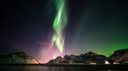 Breathtaking Northern Lights Over Snowy Mountains Desktop Wallpaper