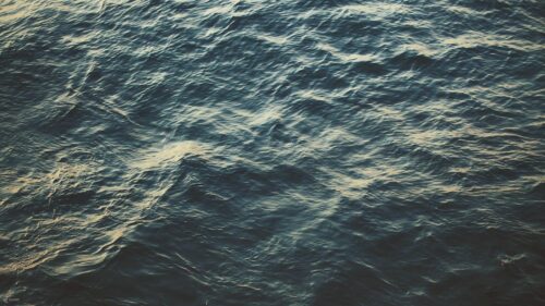 Deep Blue Sea Surface with Golden Sunlight Reflections Desktop Wallpaper