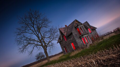Eerie Abandoned House with Glowing Red Windows Haunted Night PC Wallpaper