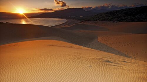 Breathtaking Golden Sunset Over Sand Dunes and Ocean 4K Wallpaper