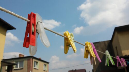 Colorful Clothespins on Clothesline Against Sunny Blue Sky PC Wallpaper
