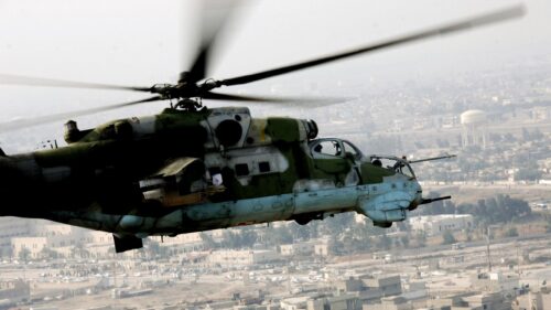 Military Mil Mi 24 Hind Attack Helicopter Flying Over City 4K Wallpaper