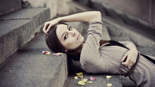 Melancholic Portrait of a Beautiful Woman Lying on Stone Steps PC Wallpaper