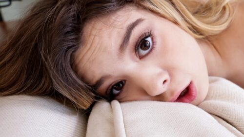 Beautiful Young Woman Resting on Pillow Portrait Desktop Wallpaper