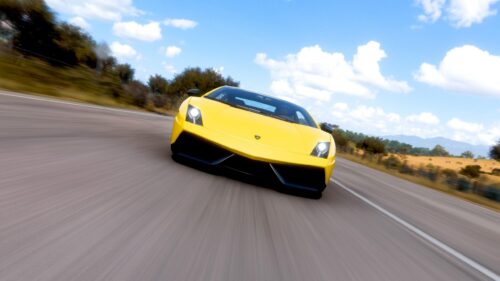 Bright Yellow Lamborghini Gallardo Speeding on Open Road PC Wallpaper