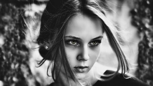 Stunning Portrait of a Woman with Piercing Green Eyes Desktop Wallpaper