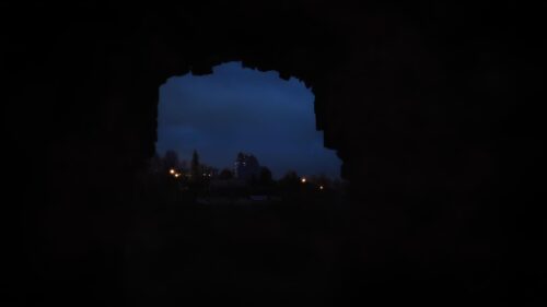 Mysterious Dark Tunnel View of a Distant Illuminated Building PC Wallpaper
