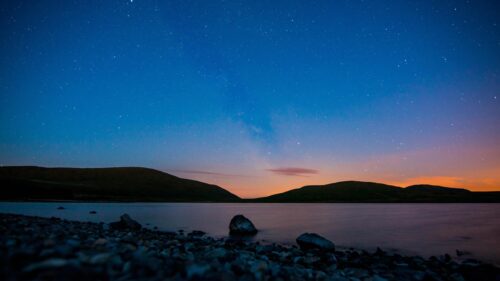 Breathtaking Night Sky Over Mountain Lake 4K Wallpaper