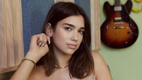Stunning Portrait of Pop Star Dua Lipa with Electric Guitar Background 4K Wallpaper