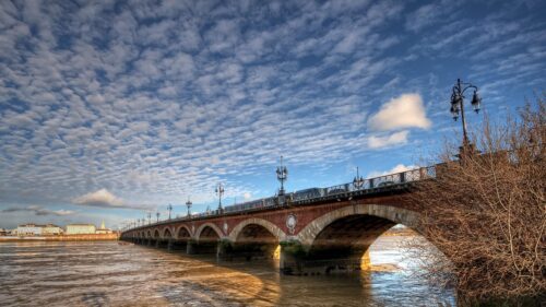 Stunning Stone Arch Bridge Over Garonne River in Bordeaux 4K Wallpaper