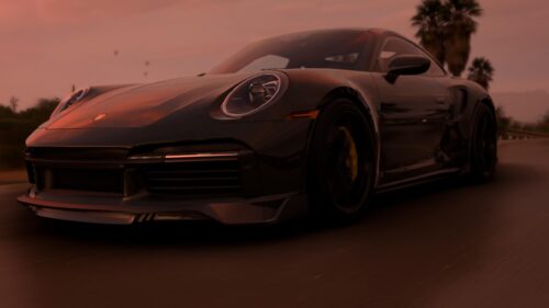 Stunning Black Porsche 911 Driving at Sunset Desktop Wallpaper