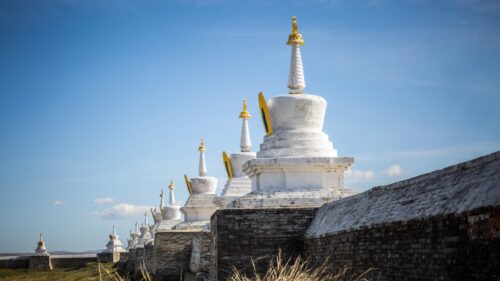 Stunning Row of Buddhist White Stupas Under a Clear Blue Sky PC Wallpaper