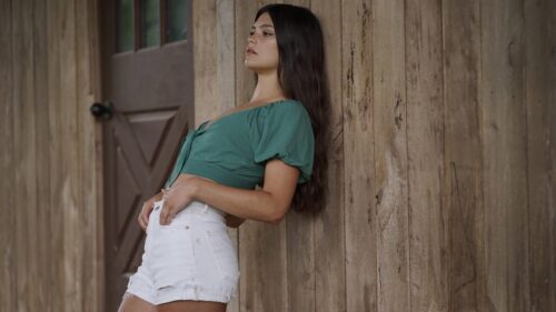 Beautiful Young Woman Leaning Against Rustic Wooden Wall PC Wallpaper