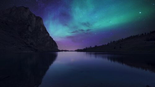Stunning Aurora Borealis Over Calm Mountain Lake 4K Wallpaper