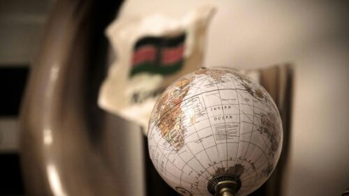 Macro Shot of a Globe with African Flag Background 4K Wallpaper