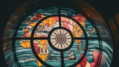 Stained Glass World Map with Compass and Ship 4K Desktop Wallpaper