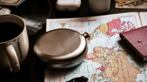 Travel Adventure Essentials with World Map and Coffee Desktop Wallpaper