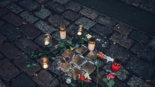 Stolpersteine Memorial Candles and Flowers 4K Wallpaper
