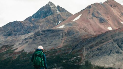 Hiker Exploring Majestic Mountain Landscape 4K Desktop Wallpaper