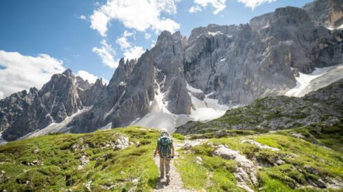 Hiker Trekking Through Majestic Dolomite Mountains 4K Wallpaper