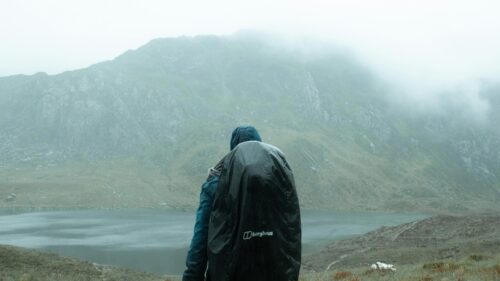 Lone Hiker Exploring Misty Mountains Lake Landscape Desktop Wallpaper