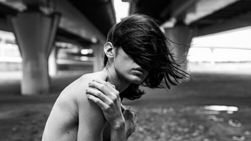 Moody Black and White Portrait of a Person Under a Bridge 4K Wallpaper