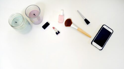 Minimalist Beauty Desk Aesthetic with Makeup and Smartphone Desktop Wallpaper