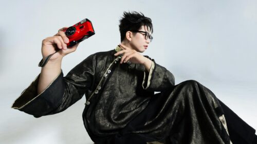 Stylish Man Holding Red Vintage Camera Artistic 4K Desktop Wallpaper