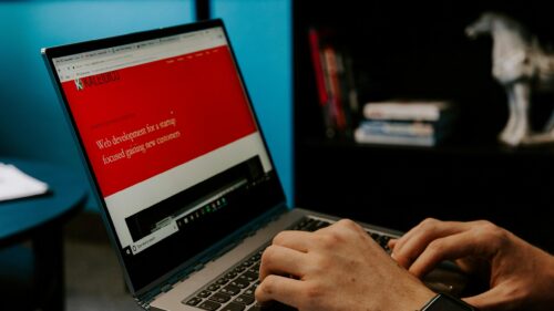 Person Working on Laptop Screen with Startup Website Desktop Wallpaper